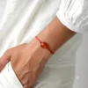 Amber bracelet red string cognac 1