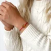Red string bracelet with honey amber 1