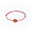 Red string bracelet with cognac amber