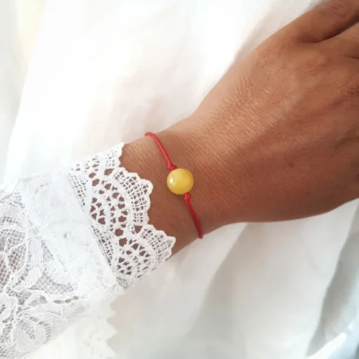 Red string bracelet with milky amber 1