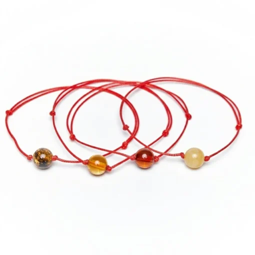 Red string bracelets with amber